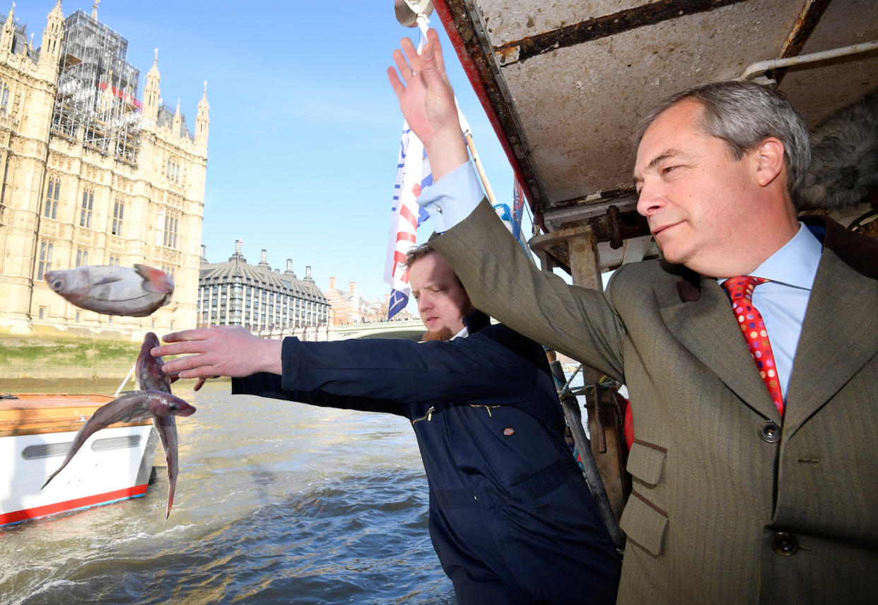 Nigel Farage and the founder of Fishing for Leave, Aaron Brown, dump fish into the River Thames (Picture: Reuters)