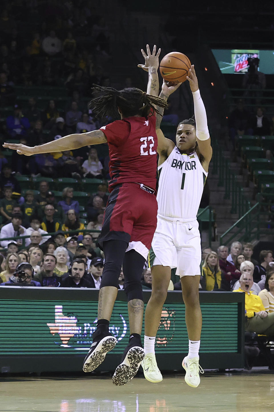 Baylor guard Keyonte George (1) shoots a 3-pointer past Nicholls State forward Manny Littles (22) during the first half of an NCAA college basketball game Wednesday, Dec. 28, 2022, in Waco, Texas. (AP Photo/Jerry Larson)