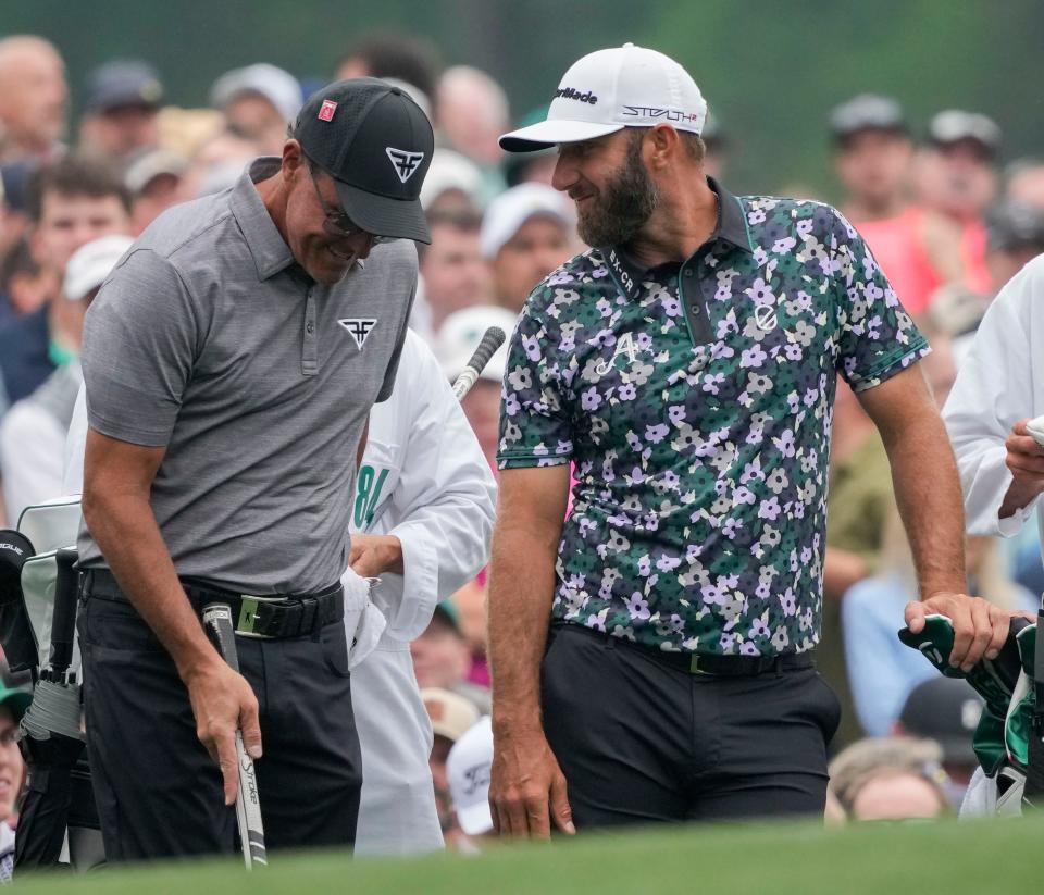 Phil Mickelson and Dustin Johnson share a laugh during a practice round before the Masters.