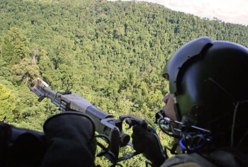 This file photo shows a Philippine Air Force gunner manning a machine gun as a helicopter flies over an area in restive southern Philippines, in 2008. A new video has emerged of an Australian kidnapped by suspected Muslim extremists in the Philippines, with the foreign office on Monday saying it proved he was still alive in late March