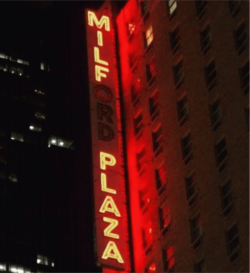 Sign for "MILFORD PLAZA" with the ORD burnt out