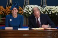 Catherine the Duchess of Cambridge (L) and Prince Williame sign the Canadian government's Golden Book at the Legislative Assembly in Victoria, British Columbia