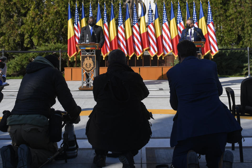 U.S. Defense Secretary Lloyd Austin, left, stands during a joint press conference with Romanian Defense Minister Nicolae Ciuca during a welcoming ceremony in Bucharest, Romania, Wednesday, Oct. 20, 2021. Austin is visiting Romania before attending the NATO Defense Ministerial in Brussels. (AP Photo/Andreea Alexandru)