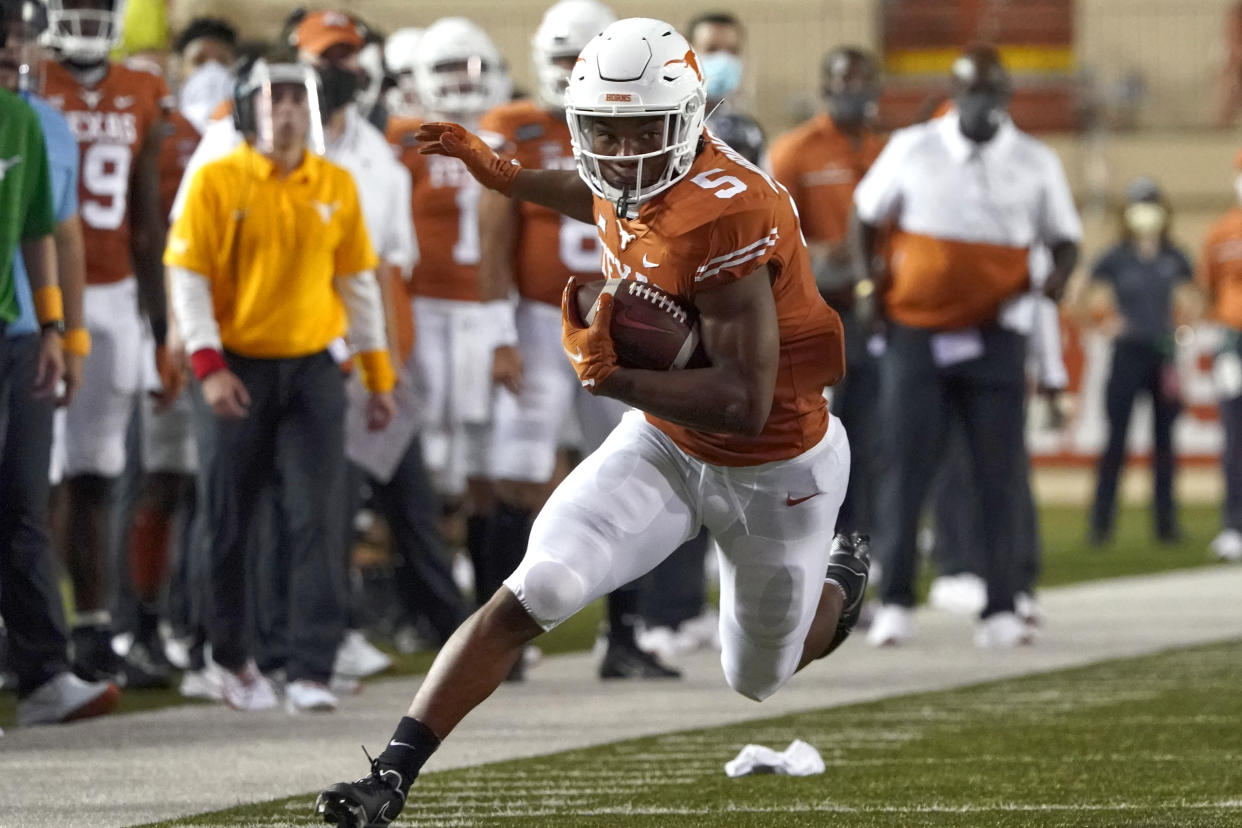 Texas' Bijan Robinson (5) runs for a long gain after a catch against UTEP during the first half of an NCAA college football game in Austin, Texas, Saturday, Sept. 12, 2020. (AP Photo/Chuck Burton)