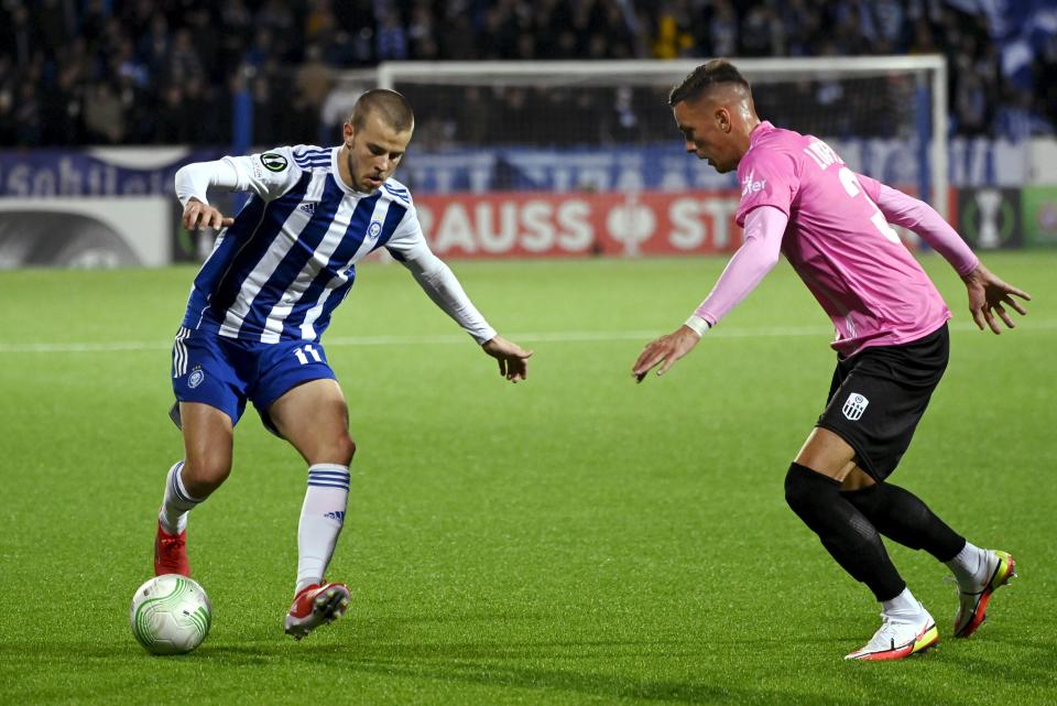 Helsinki's Roope Riski, left, and Felix Luckeneder of LASK battle for the ball during the Europa Conference League Group A soccer match between HJK Helsinki and LASK Lienz in Helsinki, Finland, Thursday Sept. 16, 2021. (Emmi Korhonen/Lehtikuva via AP)