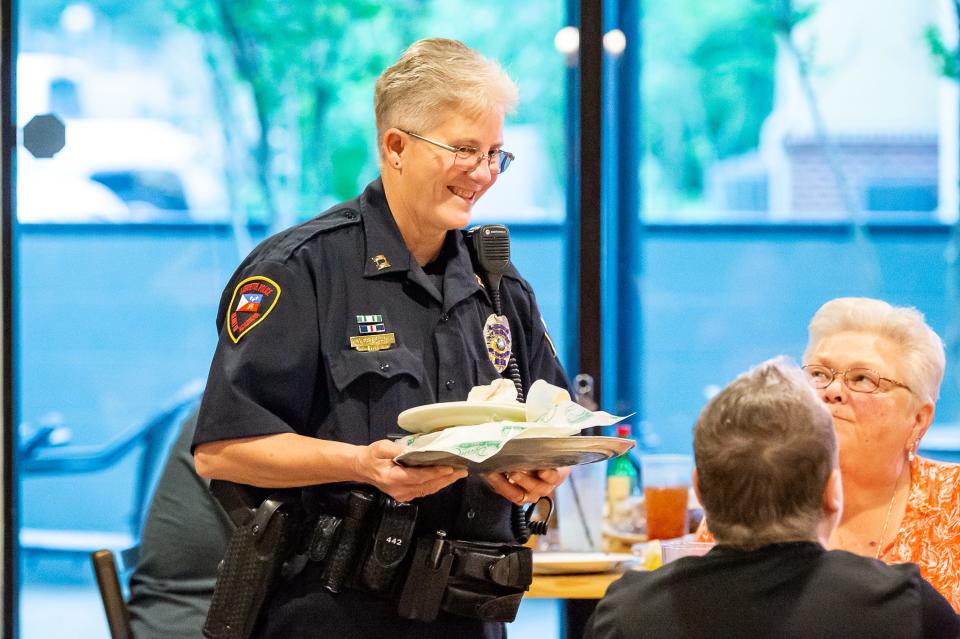 Lafayette Police Officers wait tables Wednesday at Deano's Pizza, with tips going to Boys and Girls Clubs.