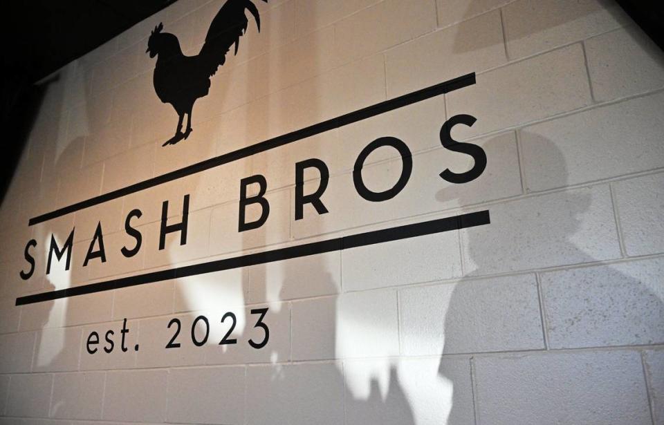 Las sombras de los clientes en la fila se reflejan en una pared del Smash Bros Bistro.