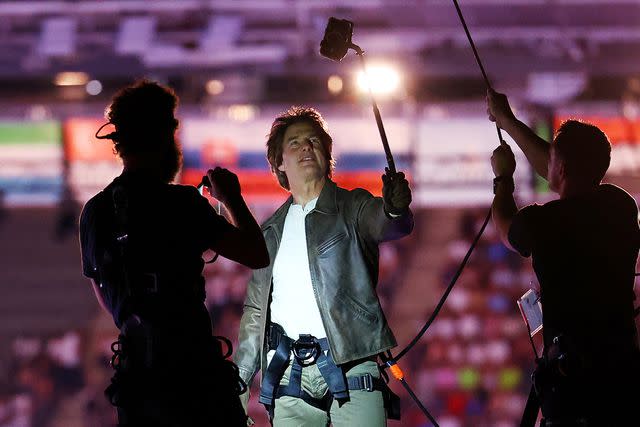 <p>Fabrizio Bensch- Pool/Getty</p> Tom Cruise at the 2024 Olympics closing ceremony in Paris