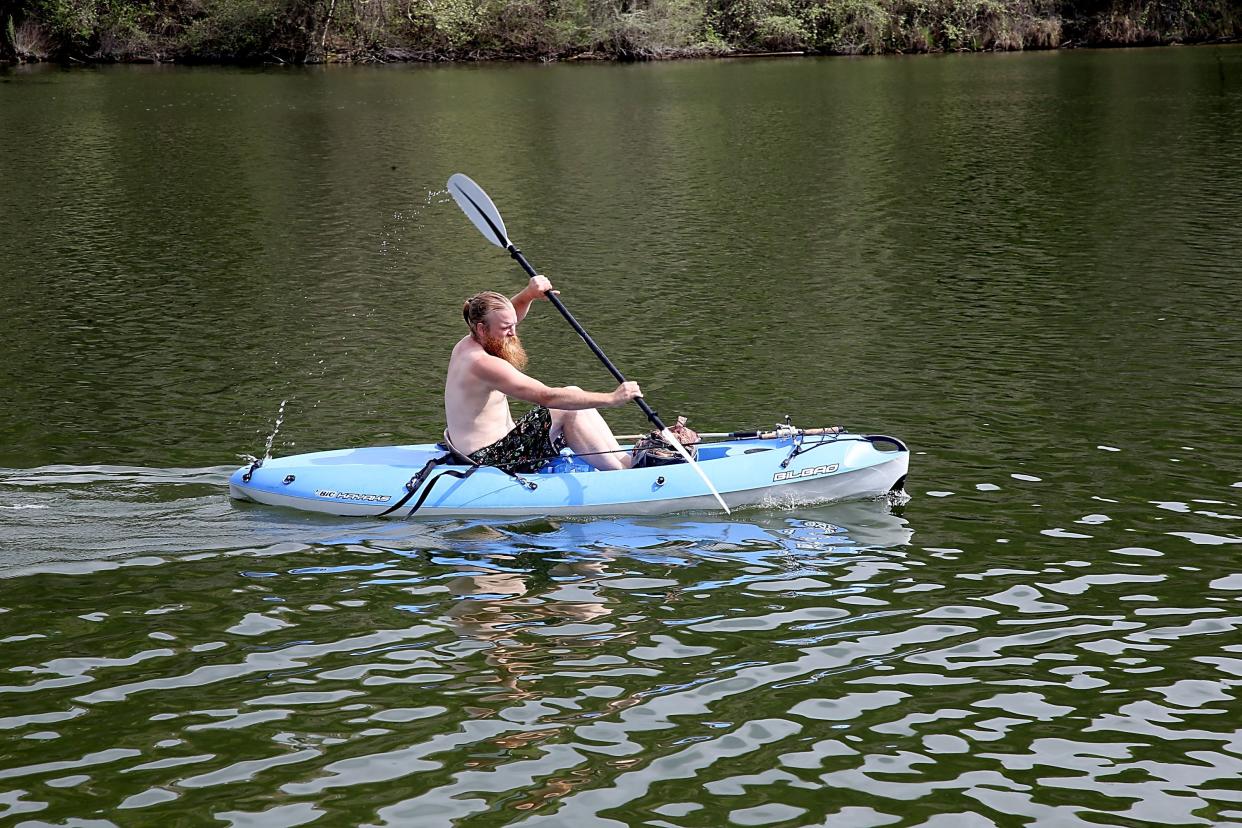 A man kayaks in Austin, Texas. (Photo by Gary Miller/Getty Images for GQ Jam In The Van)