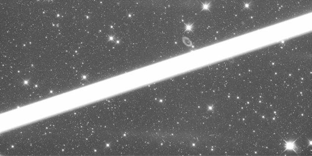 Astronomers say this streak in a Hubble Space Telescope image is likely to have been created by a Starlink satellite flying just a few miles above Hubble. (MAST Image via Nature Astronomy / Simon Porter)