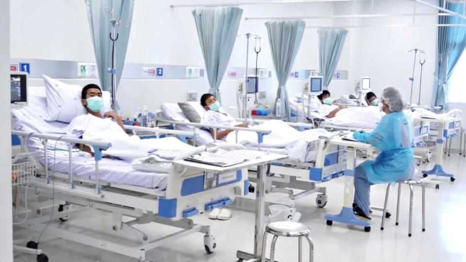 Boys rescued from the Thai cave wearing masks and resting in a hospital in Chiang Rai. Source: Reuters/Thai Government PRD