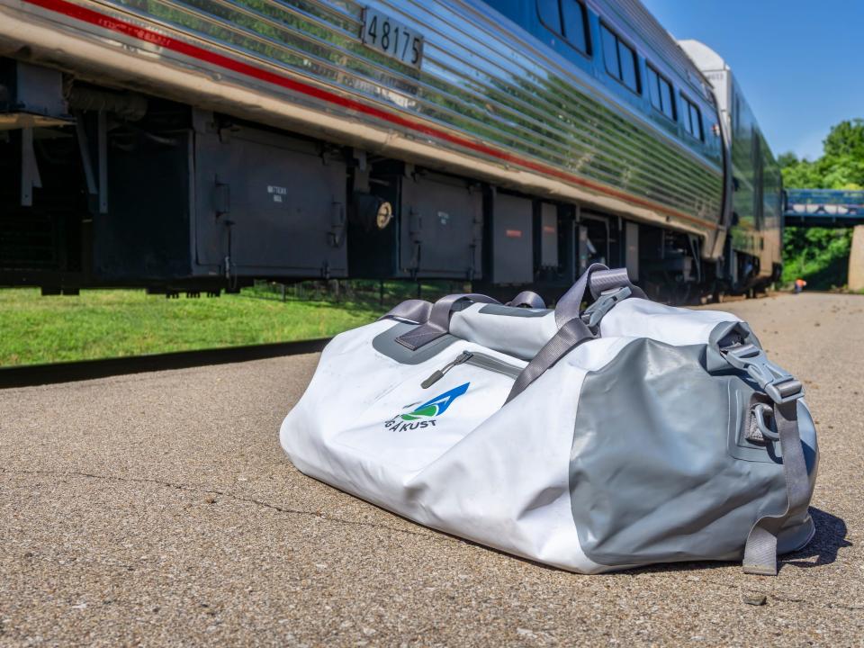 a bag in front of an amtrak train