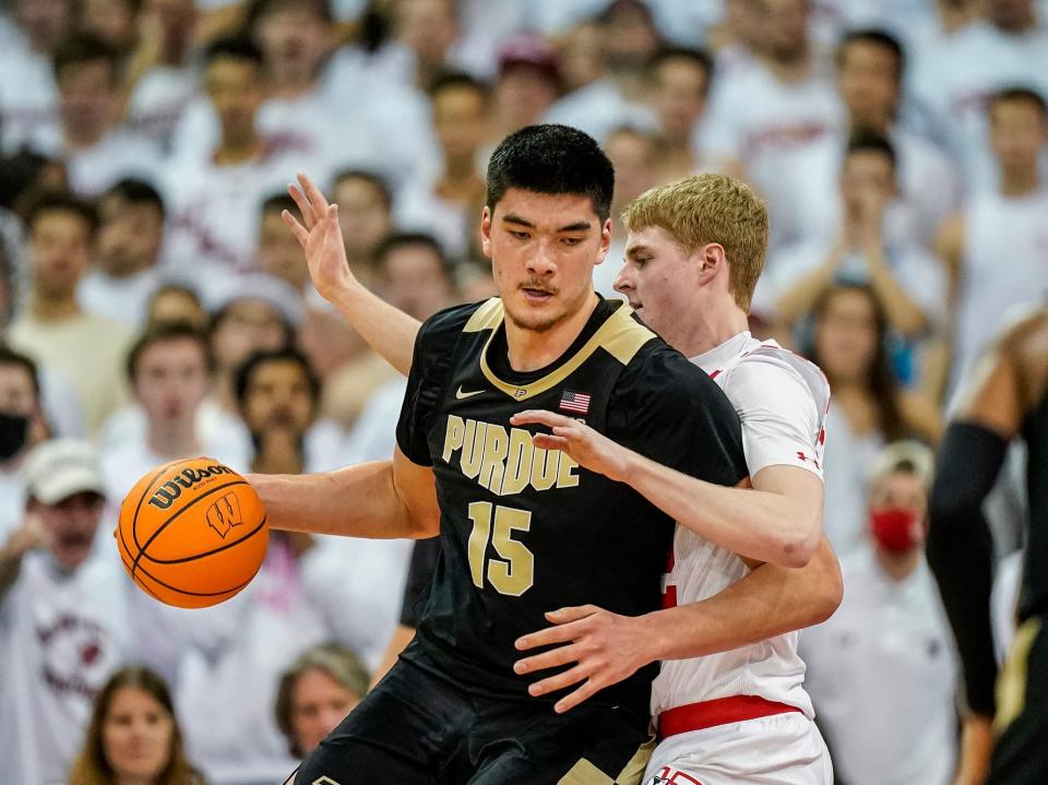 Purdue's Zach Edey backs down Wisconsin's Steven Crowl.