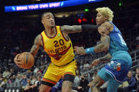 Atlanta Hawks forward John Collins (20) drives past Charlotte Hornets forward Kelly Oubre Jr. during the first half of an NBA basketball game Sunday, Dec 5, 2021, in Atlanta. (AP Photo/Edward M. Pio Roda)