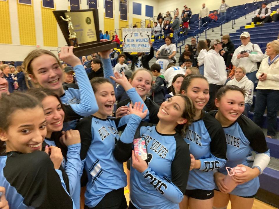 Sophomore Noelle Savonije holds up the trophy as Immaculate Conception celebrates after defeating Morris Catholic to win the NJSIAA Non-Public B volleyball title in November.