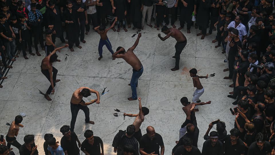 Shiite Muslim devotees self-flagellate during Ashura rituals in New Delhi, India. - Kabir Jhangiani/NurPhoto/Getty Images