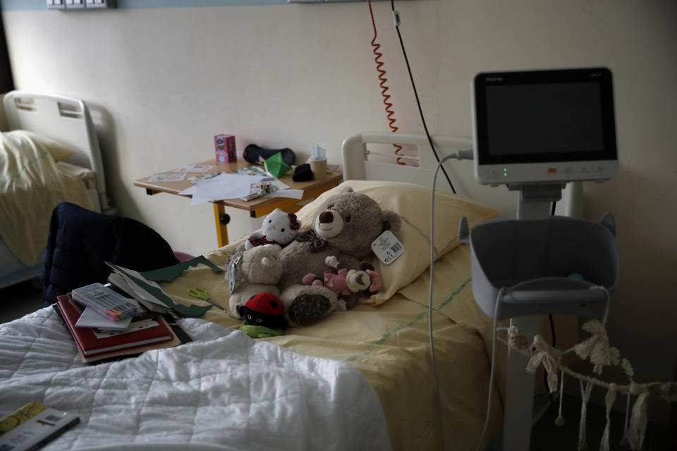 Teddy bears are placed on the bed of a child at the pediatric unit of the Robert Debre hospital, in Paris, France, Wednesday, March 3, 2021. A year into the coronavirus pandemic, increasing numbers of children are coming apart at the seams, their mental health shredded by the traumas of deaths, sickness and job losses in their families, the disruptions of lockdowns and curfews, and a deluge of anxieties poisoning their fragile young minds. (AP Photo/Christophe Ena)