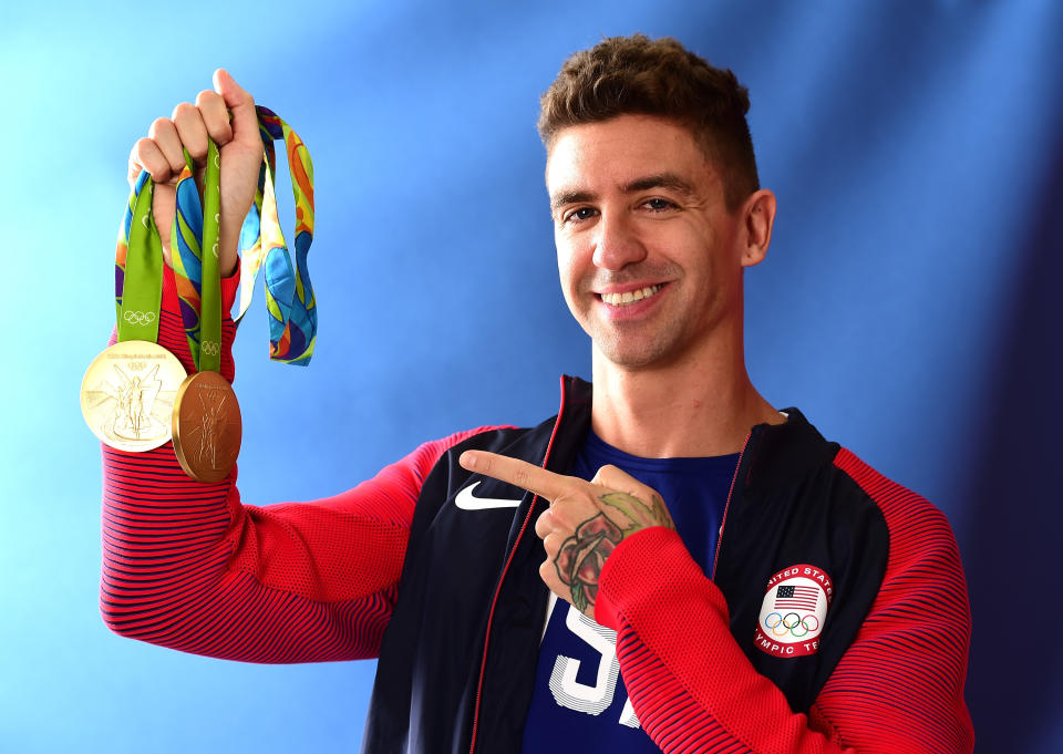 RIO DE JANEIRO, BRAZIL - AUGUST 13:  (BROADCAST - OUT) Swimmer, Anthony Ervin of the United States poses for a photo with his two gold medals on the Today show set on Copacabana Beach on August 13, 2016 in Rio de Janeiro, Brazil.  (Photo by Harry How/Getty Images)