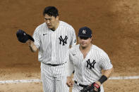 New York Yankees starting pitcher Masahiro Tanaka, left, tips his cap as he and first baseman Luke Voit leave the field in the fourth inning of a baseball game against the Atlanta Braves, Wednesday, Aug. 12, 2020, in New York. (AP Photo/Kathy Willens)