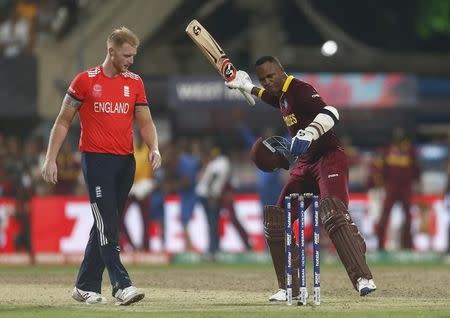 Cricket - England v West Indies - World Twenty20 cricket tournament final - Kolkata, India - 03/04/2016. West Indies Marlon Samuels (R) celebrates past England's Ben Stokes after winning the final. REUTERS/Rupak De Chowdhuri