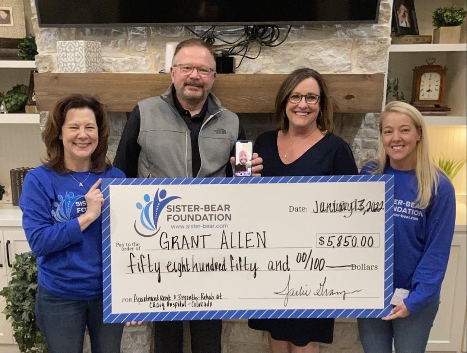 Sister-Bear Foundation board members Amy Juba, far left, and Julie Granger, far right, present a mock check and a real check for $5,850 to Grant Allen via FaceTime and his parents Doug and D'Ann Allen, middle. The Sister-Bear Foundation will host its 4th Annual Sister-Bear Shoot from 1 to 9 p.m. Saturday at River Breaks Ranch, 7802 Durrett Dr.