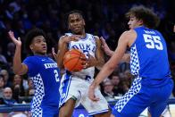 Duke's Jeremy Roach (3) protects the ball from Kentucky's Sahvir Wheeler (2) and Lance Ware (55) during the first half of an NCAA college basketball game Tuesday, Nov. 9, 2021, in New York. (AP Photo/Frank Franklin II)