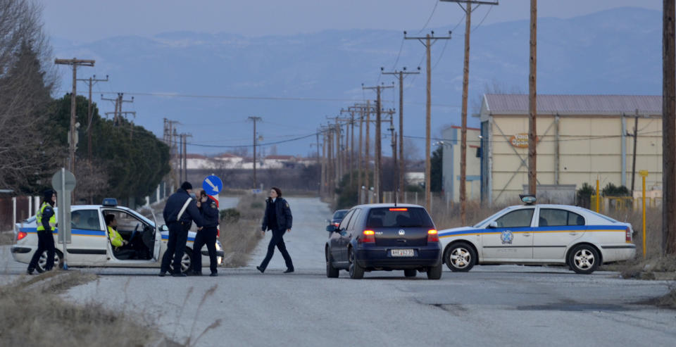 Police secure the area around a factory in the northern city of Komotini, about 800 kilometers (500 miles) northeast of Athens, Thursday, March 1, 2012. An unemployed man shot and wounded two people and took two others hostage at the plastics factory. The shooter, who was fired from the factory eight months ago, burst into the site with a with a shotgun, wounding a member of the management and another employee, police said. (AP Photo / Nikolas Giakoumidis)