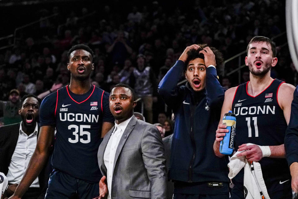 Connecticut players and coaches react to the referee's whistle during the first half of an NCAA college basketball game against Texas in the final of the Empire Classic tournament in New York, Monday, Nov. 20, 2023. (AP Photo/Peter K. Afriyie)
