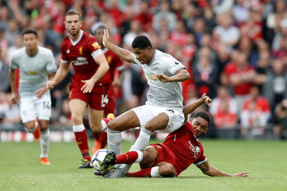 <p>Liverpool’s Joe Gomez deals with Marcus Rashford</p>