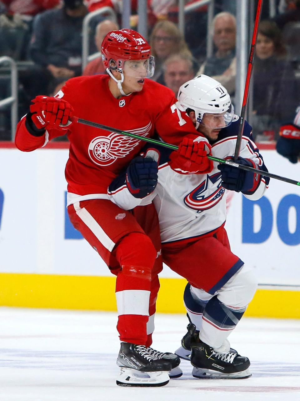 Detroit Red Wings left wing Kirill Tyutyayev (79) holds Columbus Blue Jackets center Brandon Dubinsky (17) with his stick during the second period on Saturday, Oct. 2, 2021, at Little Caesars Arena in Detroit.