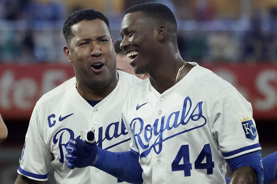 Kansas City Royals' Dairon Blanco (44) celebrates with Salvador Perez after their baseball game against the Seattle Mariners Monday, Aug. 14, 2023, in Kansas City, Mo. The Royals won 7-6. (AP Photo/Charlie Riedel)