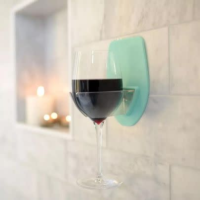 A bath and shower holder for a glass of wine