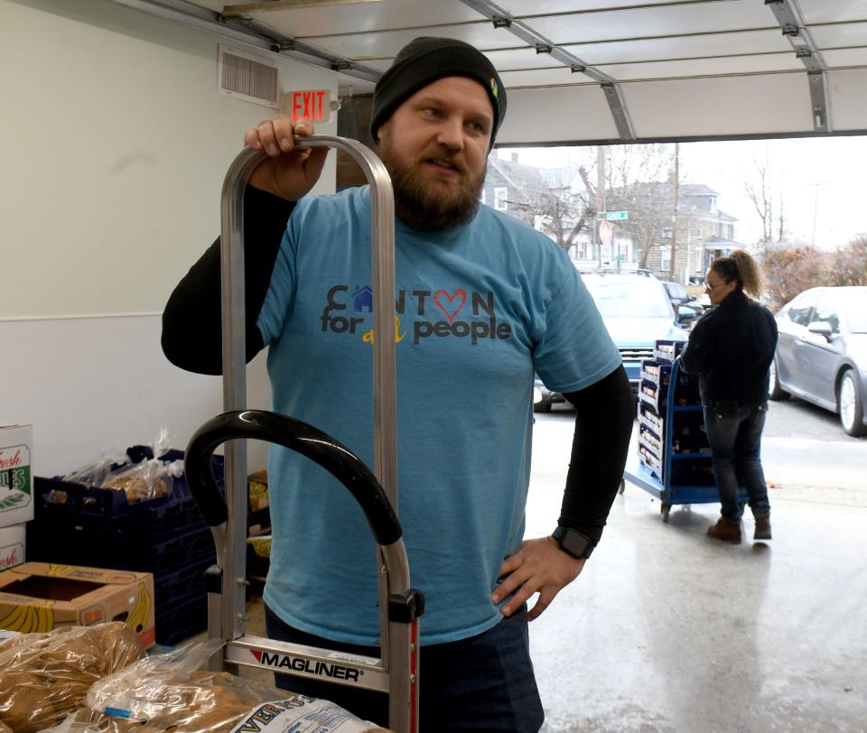 Mike Farmer, managing director for Canton For All People and associate pastor at Crossroads speaks about The Shorb Neighborhood Market and Connection Center project while delivering food.