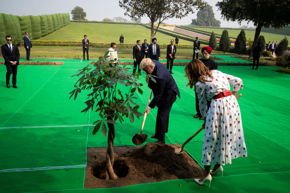 U.S. President Donald Trump and first lady Melania Trump shovel dirt as they plant a Magnolia tree at Raj Ghat in New Delhi, India, February 25, 2020. REUTERS/Al Drago