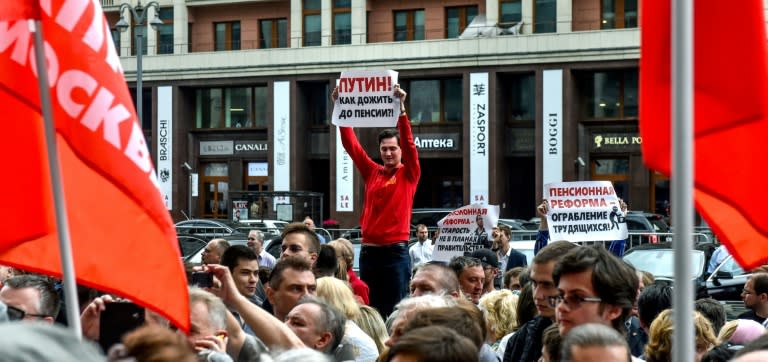 A man holds a poster reading "Putin! How to survive to retirement?" during a rally against plans to increase the Russian retirement age for both men and women