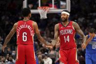 New Orleans Pelicans guard Nickeil Alexander-Walker (6) and forward Brandon Ingram (14) celebrate a basket by Ingram late in the second half of an NBA basketball game against the Dallas Mavericks in Dallas, Friday, Dec. 3, 2021. (AP Photo/Tony Gutierrez)