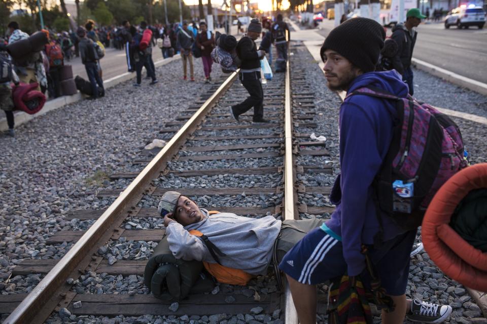 Central American migrants, part of the Central American caravan trying to reach the United States, gather near the railroad tracks as they continue their journey, in Mexicali, Mexico, Tuesday, Nov. 20, 2018. Tensions have built as nearly 3,000 migrants from the caravan poured into Tijuana in recent days after more than a month on the road, and with many more months likely ahead of them while they seek asylum in the U.S. (AP Photo/Rodrigo Abd)