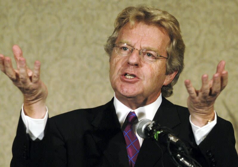 Jerry Springer raises his palms while speaking