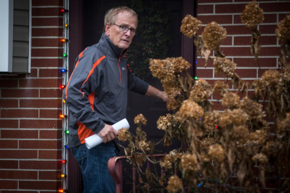 Muncie Mayor Dennis Tyler enters his home Monday afternoon after being arrested by the FBI. Tyler was indicted for theft of government funds.