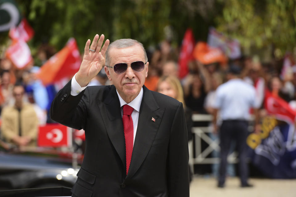 Turkish President Recep Tayyip Erdogan greets the people as arrives in the Turkish occupied area of the divided capital Nicosia, Cyprus, Monday, June 12, 2023. Erdogan is in the Turkish occupied area of north part of the Cyprus island on his first trip after his re-election after the May 28 presidential election. (AP Photo/Nedim Enginsoy)