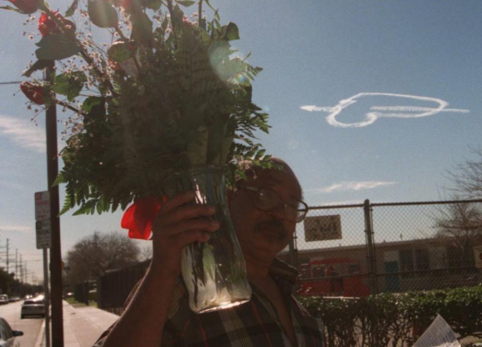 Carlos Mack delivers roses to a teacher at Telfair Ave School in Pacoima as a large heart is drawn in the sky’s above the Valley on this Valentines day in 1997.