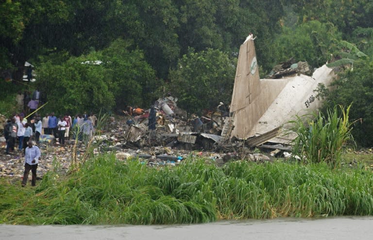 People gather at the site where a cargo plane crashed into a small farming community on a small island in the White Nile river, near South Sudan's Juba airport, on November 4, 2015