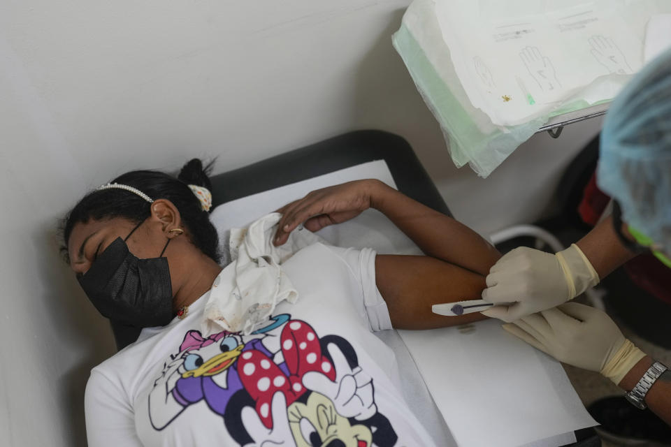 A patient receives a birth control implant at a Doctors without Borders medical clinic in Putucual, Venezuela, Wednesday, Jan. 10, 2024. A group of women and teenage girls visited the medical clinic in eastern Venezuela where a community health worker taught them how to use an IUD, condoms and birth control pills correctly and about HPV infections. (AP Photo/Matias Delacroix)