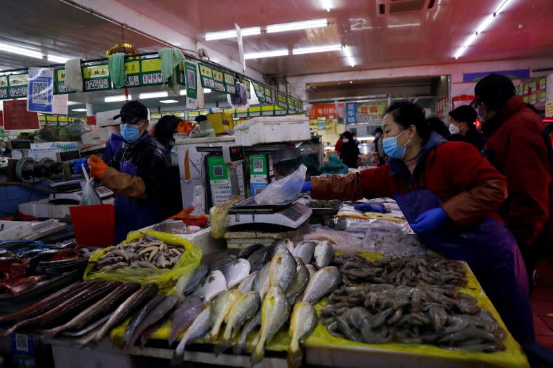 Vendors work at a market in Beijing