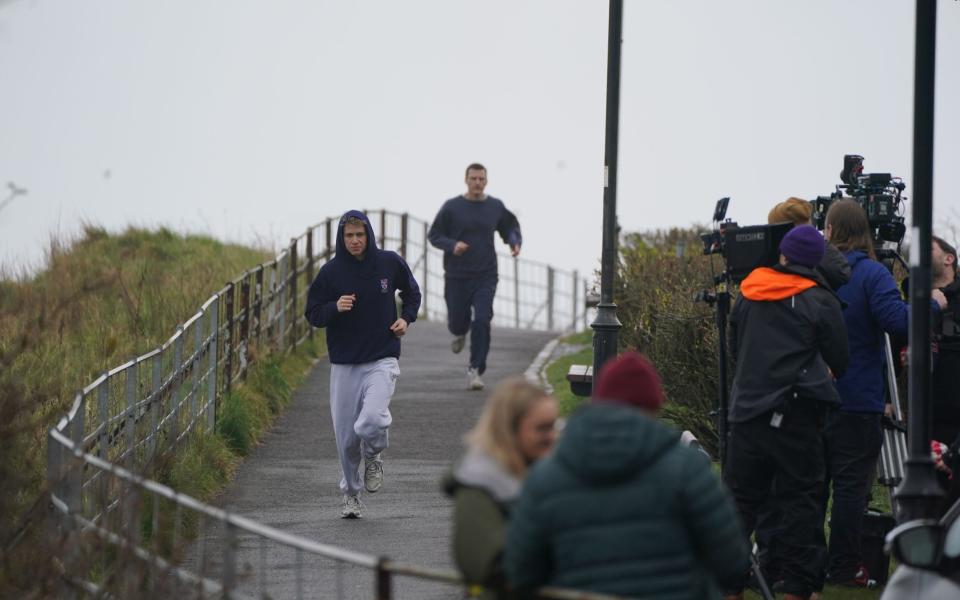 McVey jogging through the streets of St Andrews while filming - Andrew Gilligan/PA