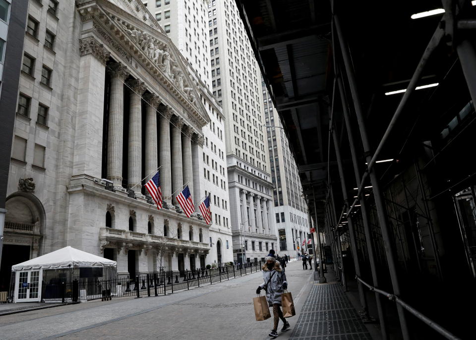 People walk outside the New York Stock Exchange (NYSE) in New York, U.S., February 12, 2021. REUTERS/Brendan McDermid