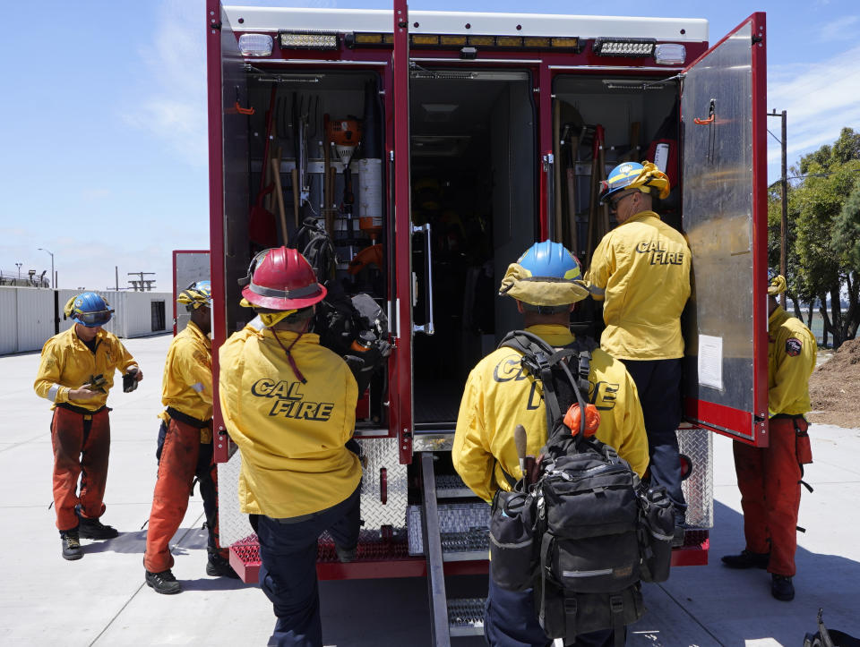 Cadets, who were formerly-incarcerated firefighters, train at the Ventura Training Center (VTC) during an open house media demonstration Thursday, July 14, 2022, in Camarillo, Calif. California has a first-in-the nation law and a $30 million training program both aimed at trying to help former inmate firefighters turn pro after they are released from prison. The 18-month program is run by Cal Fire, the California Conservation Corps, the state corrections department and the nonprofit Anti-Recidivism Coalition at the Ventura Training Center northwest of Los Angeles. (AP Photo/Damian Dovarganes)