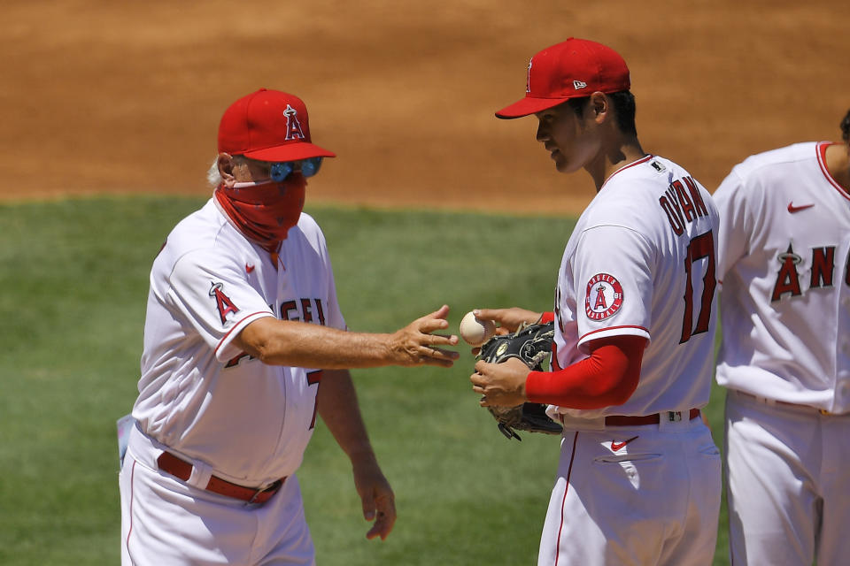 Los Angeles Angels pitcher Shohei Ohtani, right, of Japan, is taken our of the baseball game by manager Joe Maddon during the second inning against the Houston Astros on Sunday, Aug. 2, 2020, in Anaheim, Calif. (AP Photo/Mark J. Terrill)