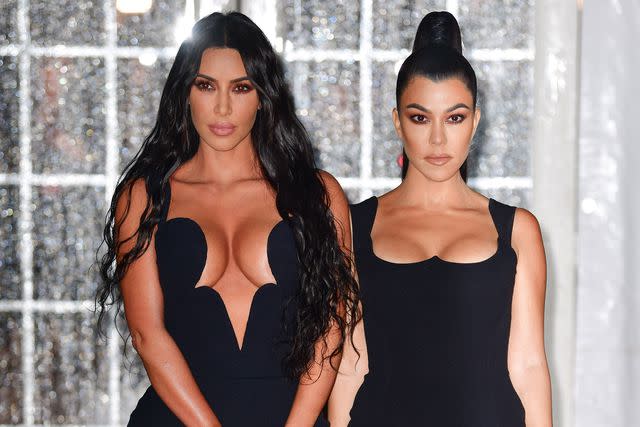 <p>James Devaney/GC Images</p> Kim Kardashian and Kourtney Kardashian attend the amfAR Gala in New York City in February 2019.