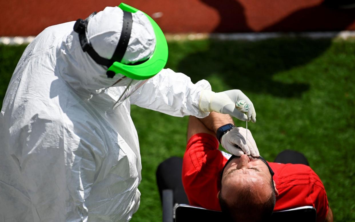 A Kosovar football referee gets tested for COVID-19 at the Fadil Vokrri Stadium in Pristina on May 30, 2020 - ARMEND NIMANI/AFP